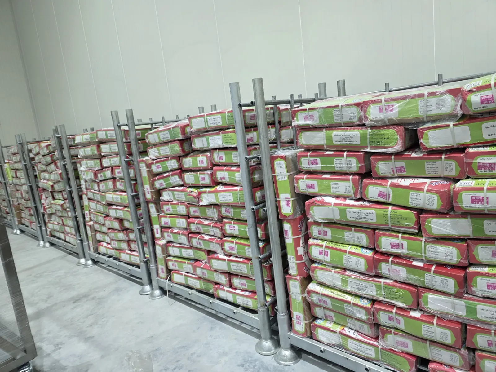 Rows of stacked frozen boneless buffalo meat cartons on pallet cages in cold storage